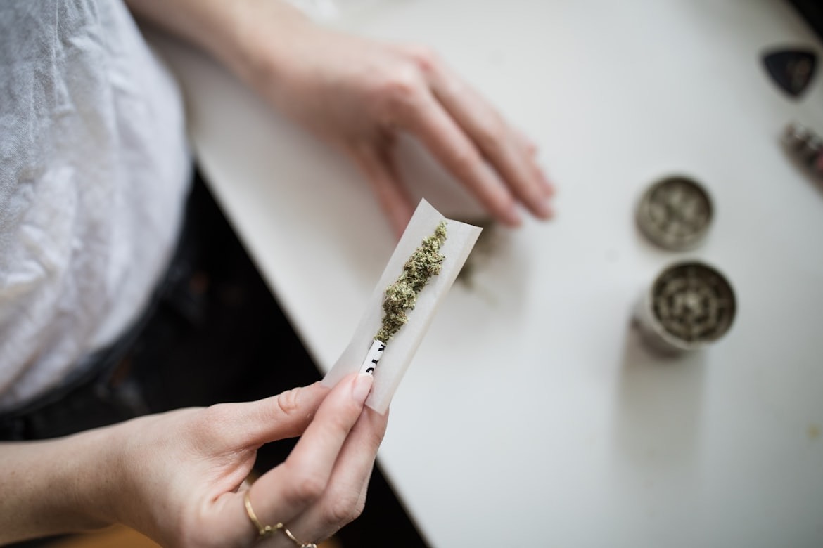 Person making cannabis joint