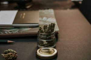 Cannabis flower in a jar on a desk